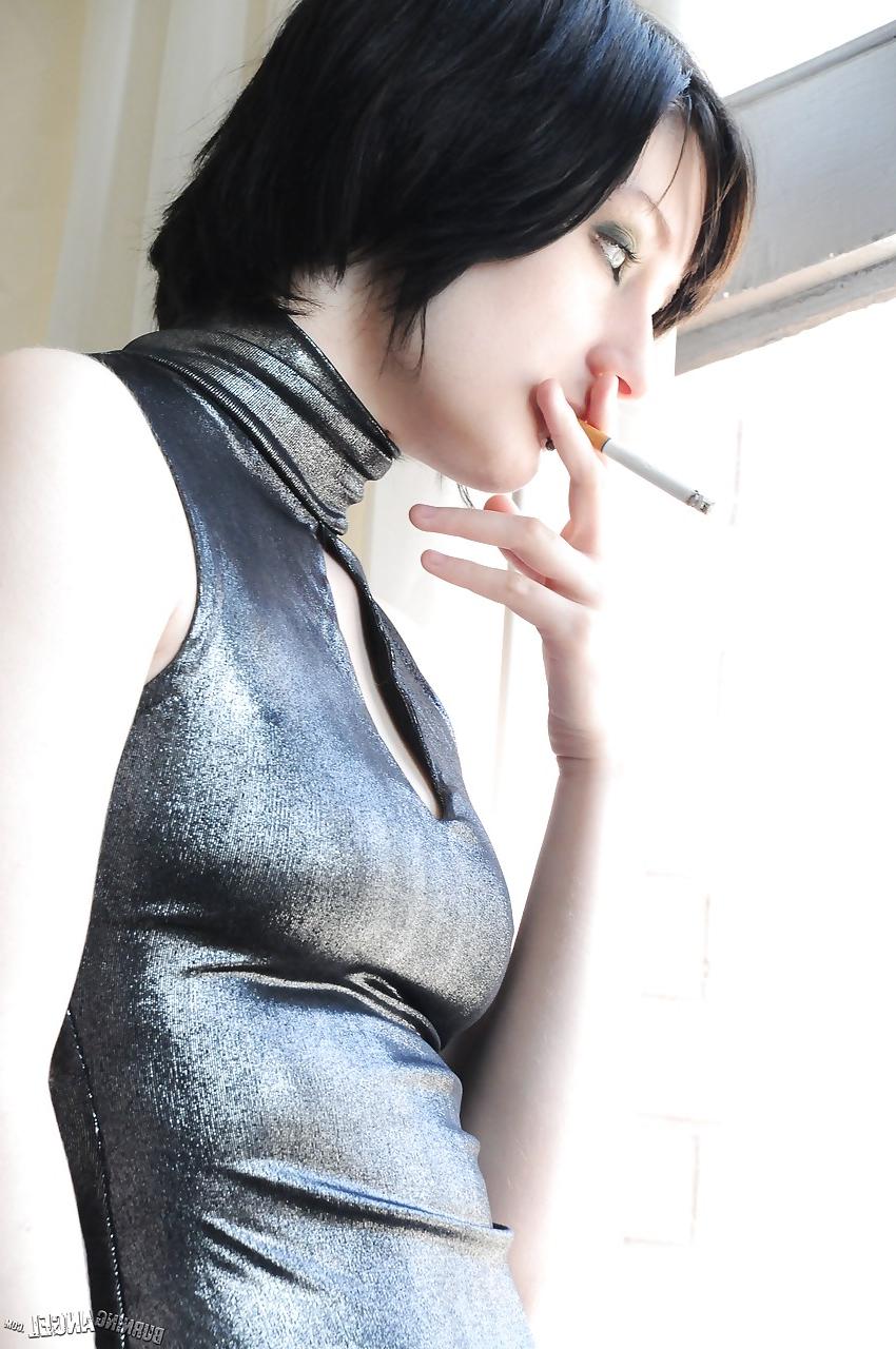 15P Tattooed brunette Violet Monroe smoking cigarette while flashing underwear