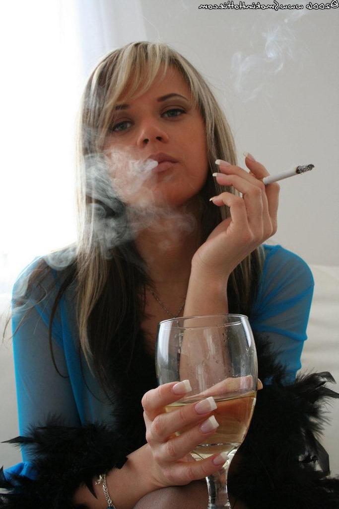 16P Pictures of Ann Angel dressed in sheer lingerie smoking a cigarette