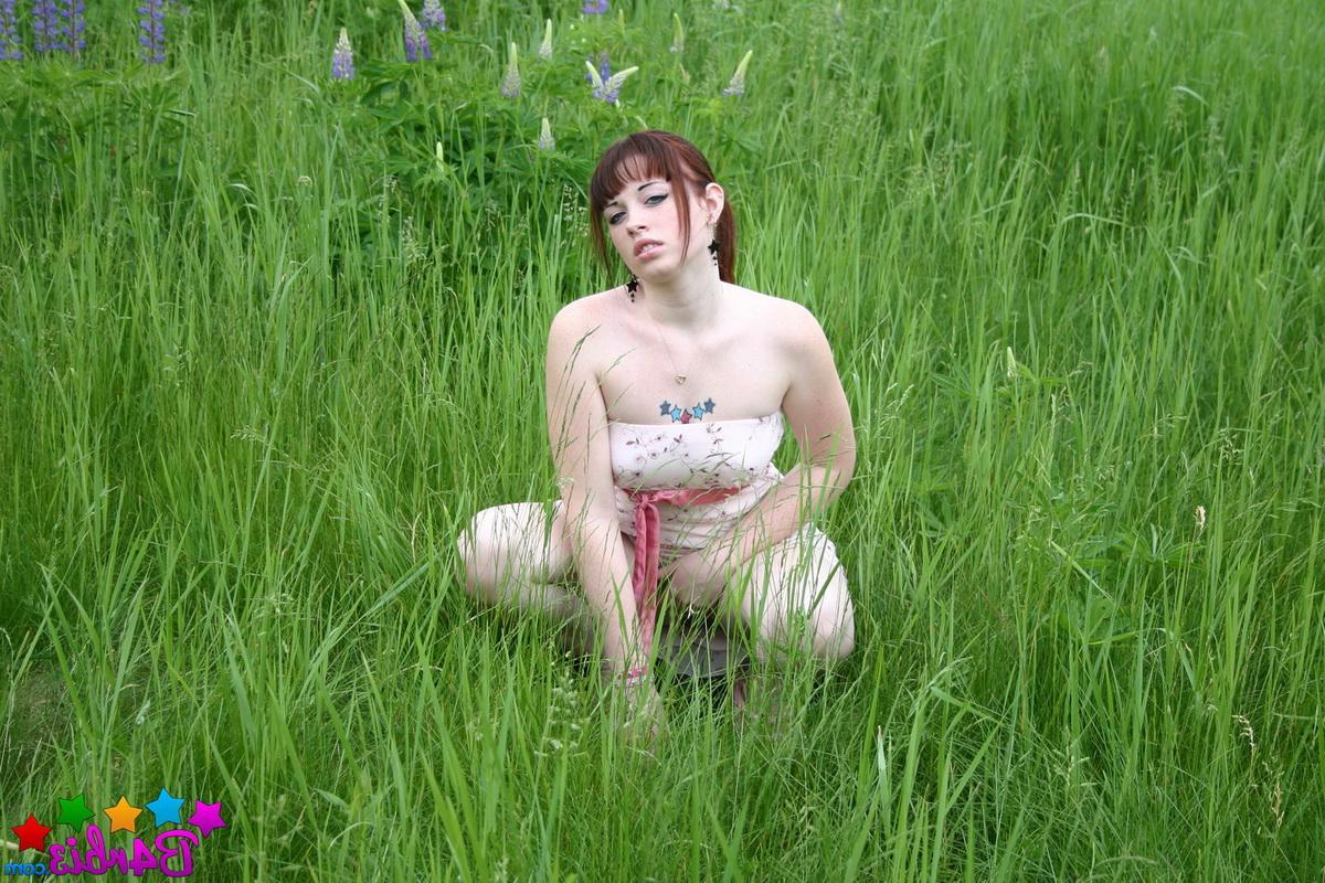 12P Barbie flashes her perfect tits and round ass outdoors in a grass field