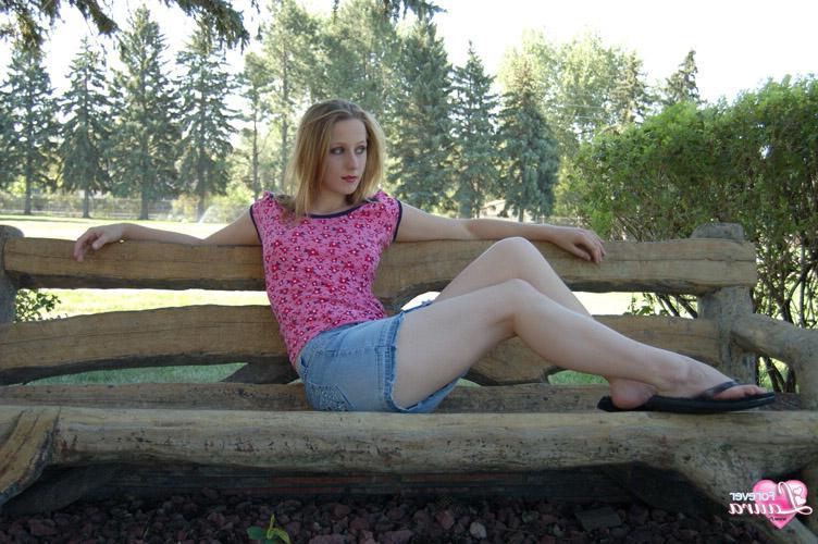 16P Beautiful redhead teen Laura is looking cute in her little denim skirt
