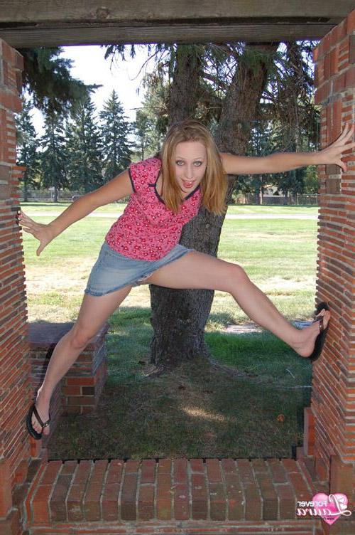 16P Beautiful redhead teen Laura is looking cute in her little denim skirt