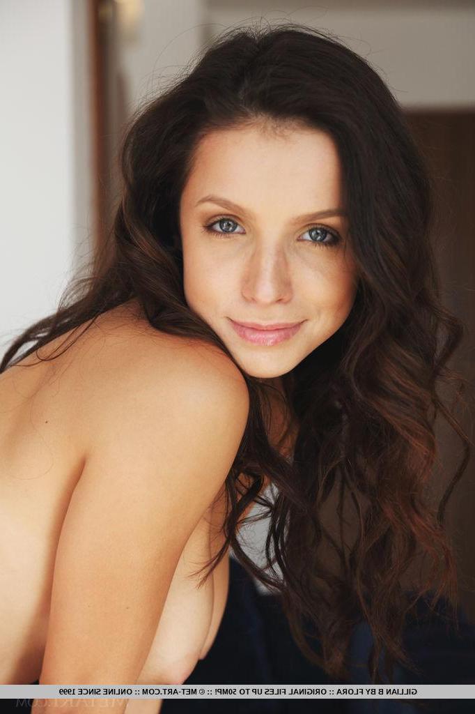 18P Brunette girl Gillian B strips naked on the couch and spreads her legs