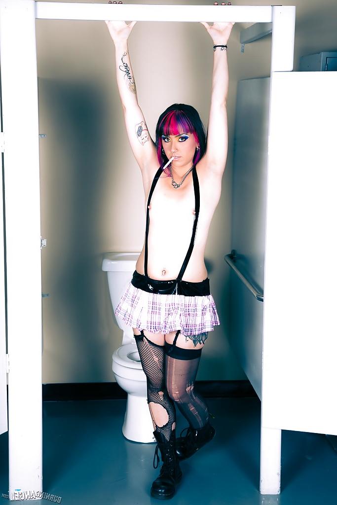 15P Frisky punk hottie in ripped stockings slowly uncovering her slim curves