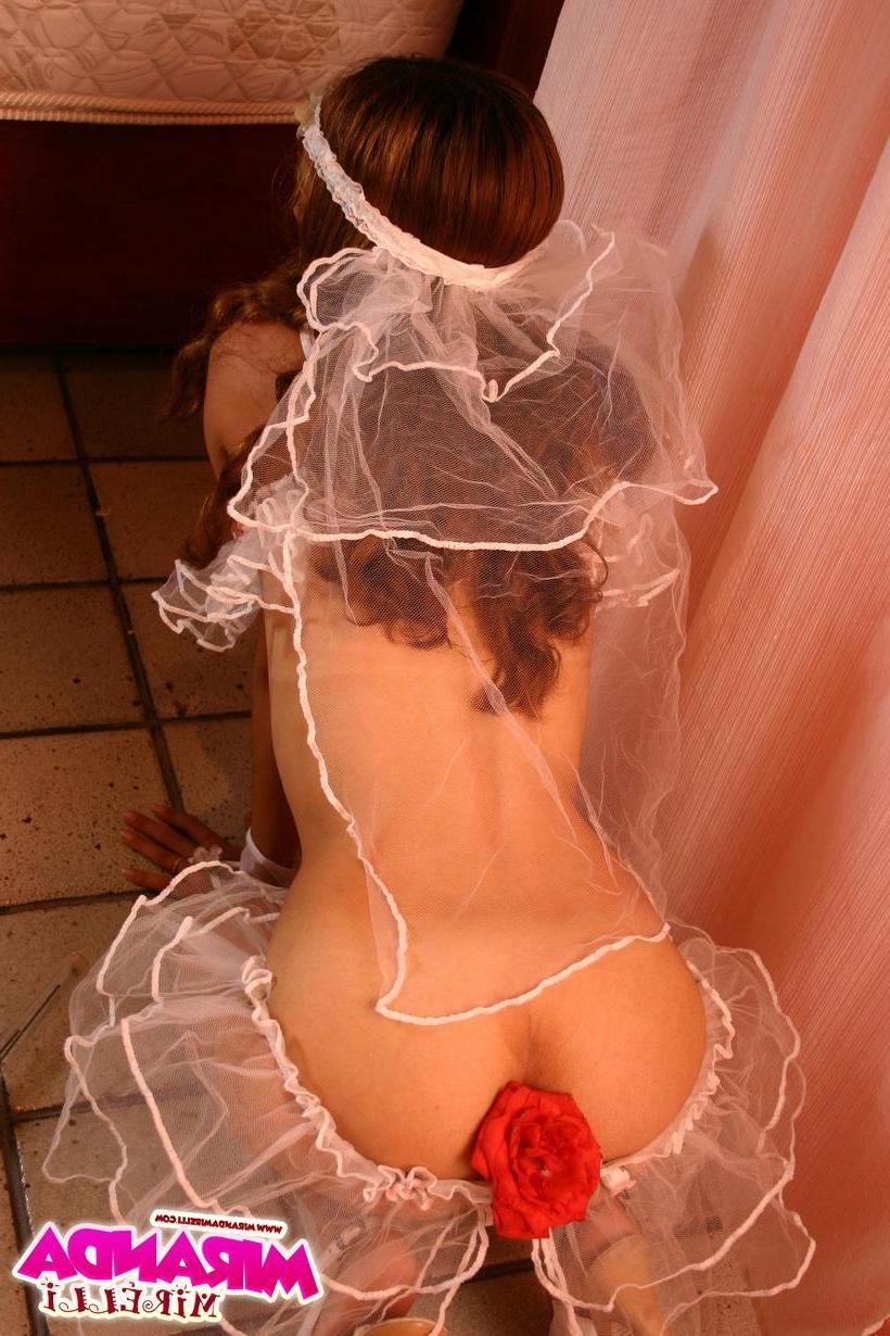 15P Miranda Mirelli in sexy bride lingerie covering her nipples with rose petals and sticking a thorny rose in her ass.