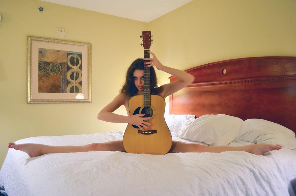 8P Sarah White poses sexy in bed with a guitar