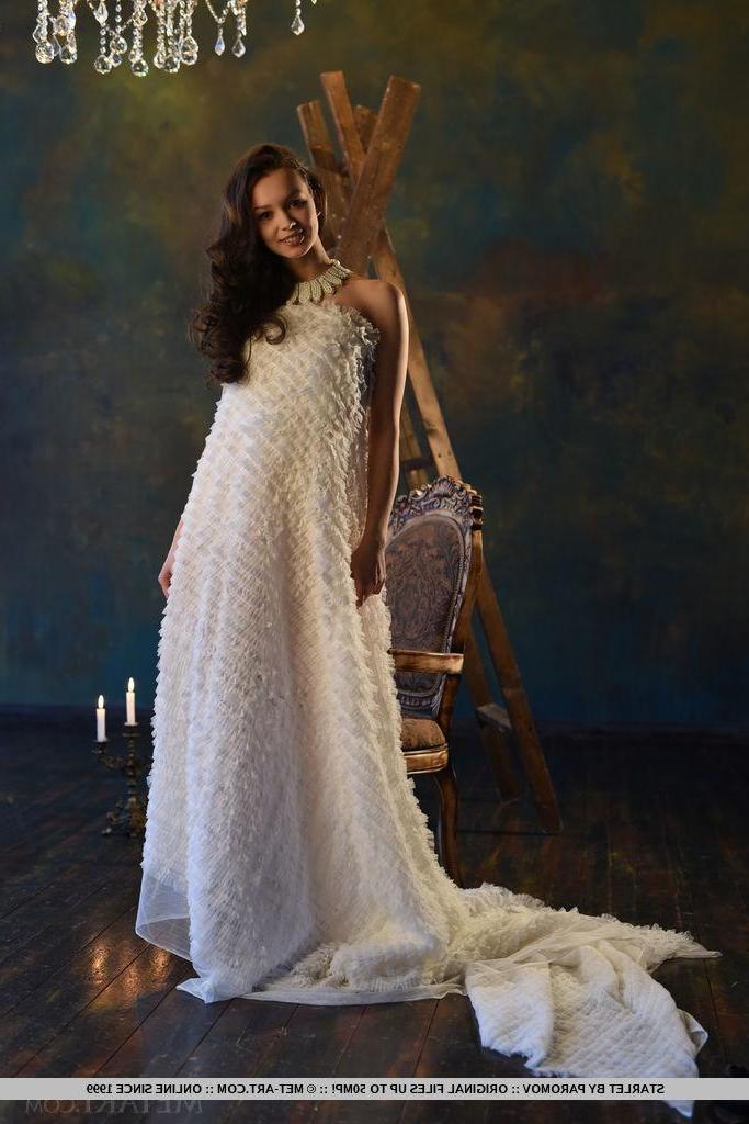 18P Starlet strips her white long gown to reveal her tight pussy on the chair