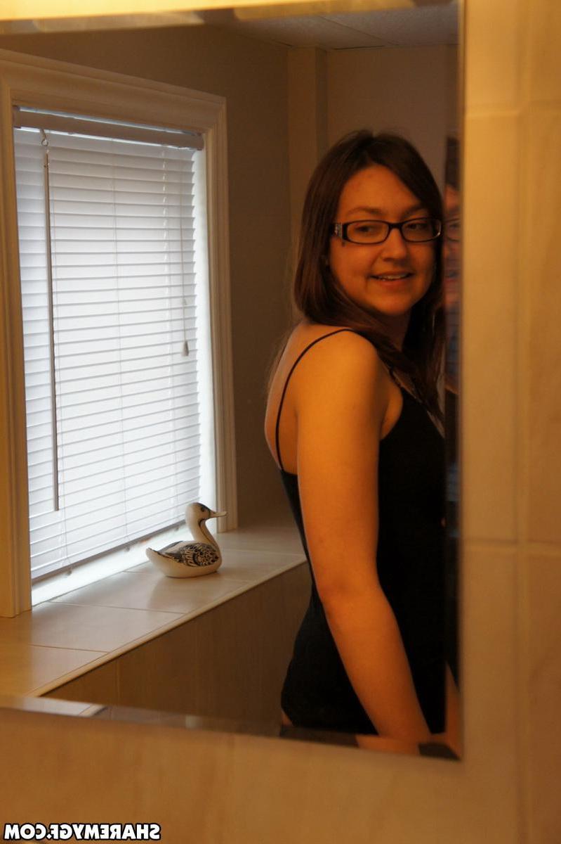 19P Hot brunette teen in glasses poses for the camera