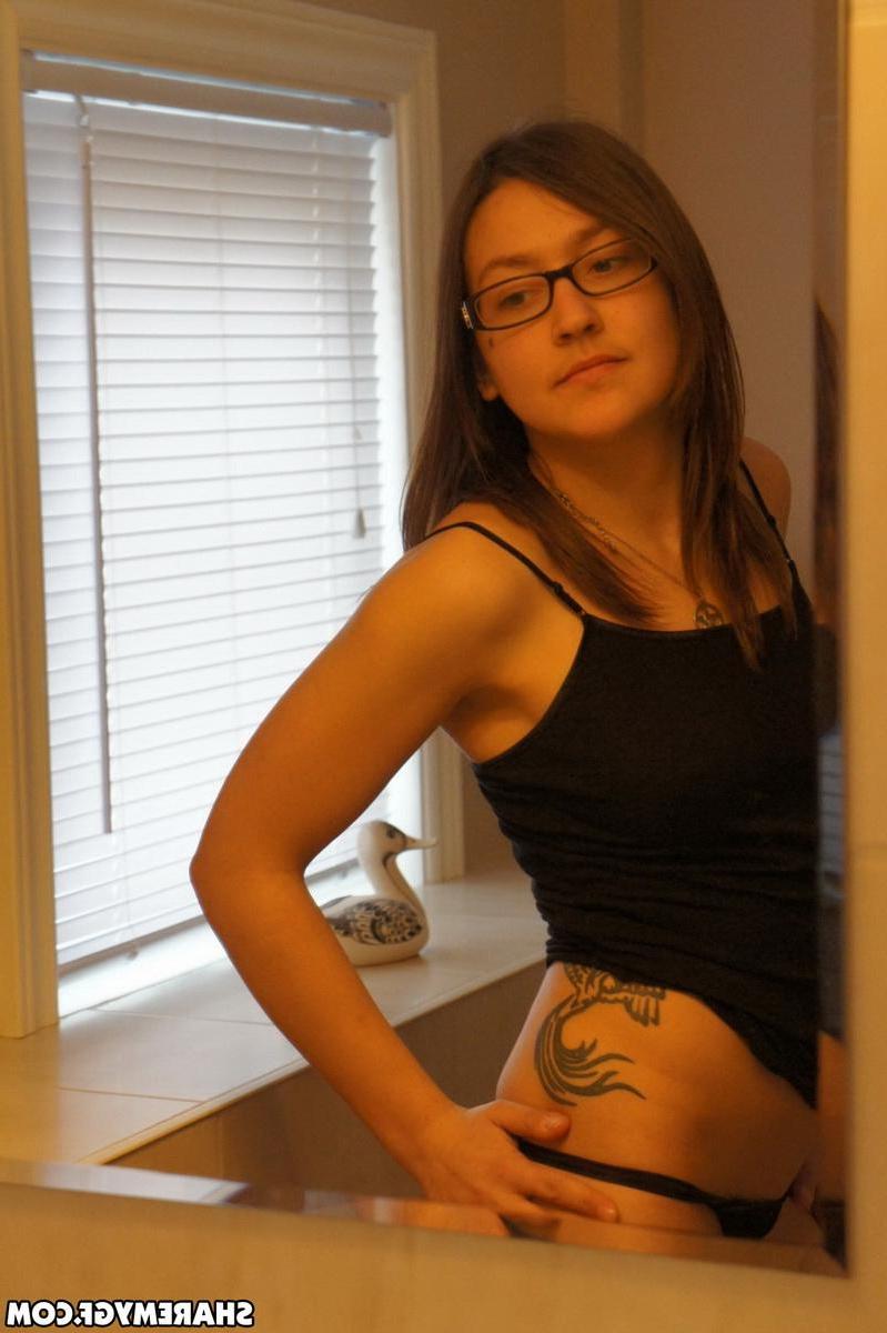 19P Hot brunette teen in glasses poses for the camera