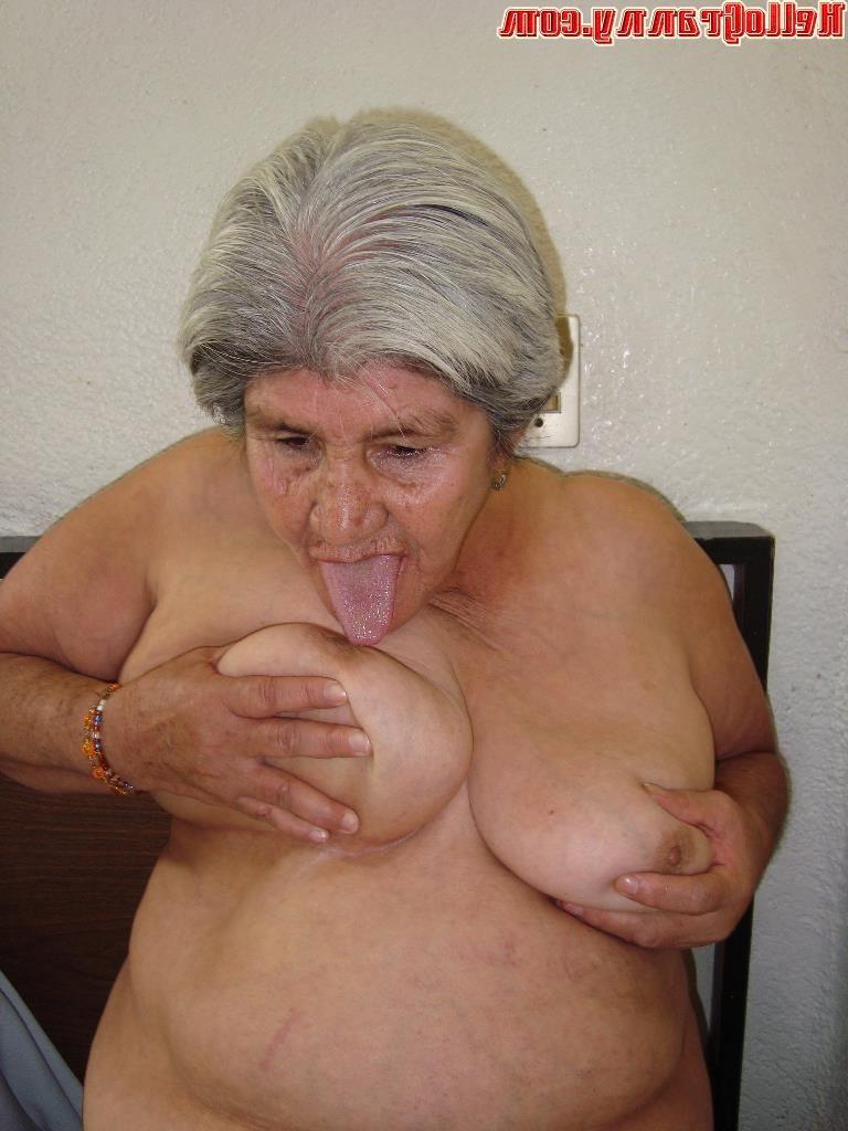 15P Nice granny licks her tits and makes striptease