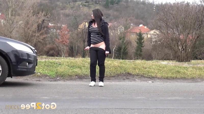 15P Chubby brunette pisses in the middle of the city
