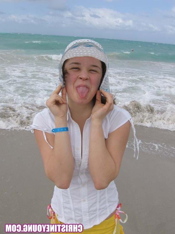 15P Cute young hottie Christine Young teasing on a nice beach
