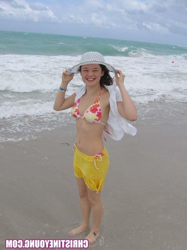 15P Cute young hottie Christine Young teasing on a nice beach