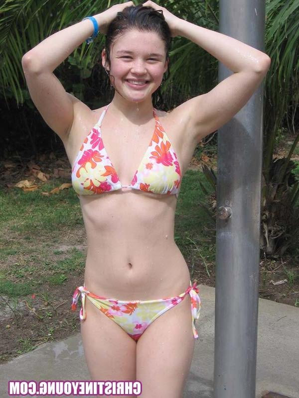 15P Cute young hottie Christine Young teasing on a nice beach