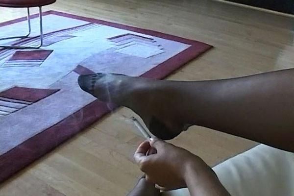 15P In pearls and stockings ... and not much else ... a girl lounges and puffs a cig