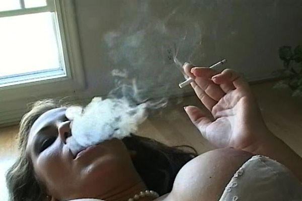 15P A smokin gal bedecked in pearls emits smoke curls into the air around her as she