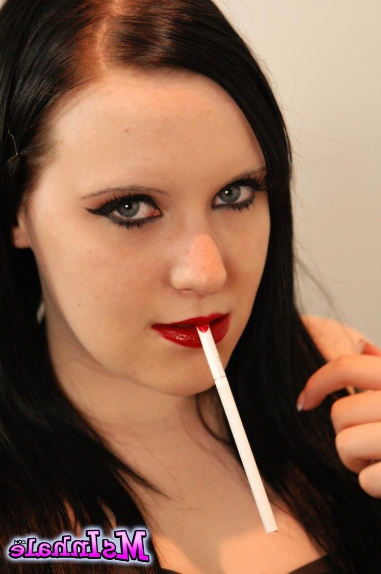 16P Naughty girl pulls her tits our of her dress as she smokes a lon