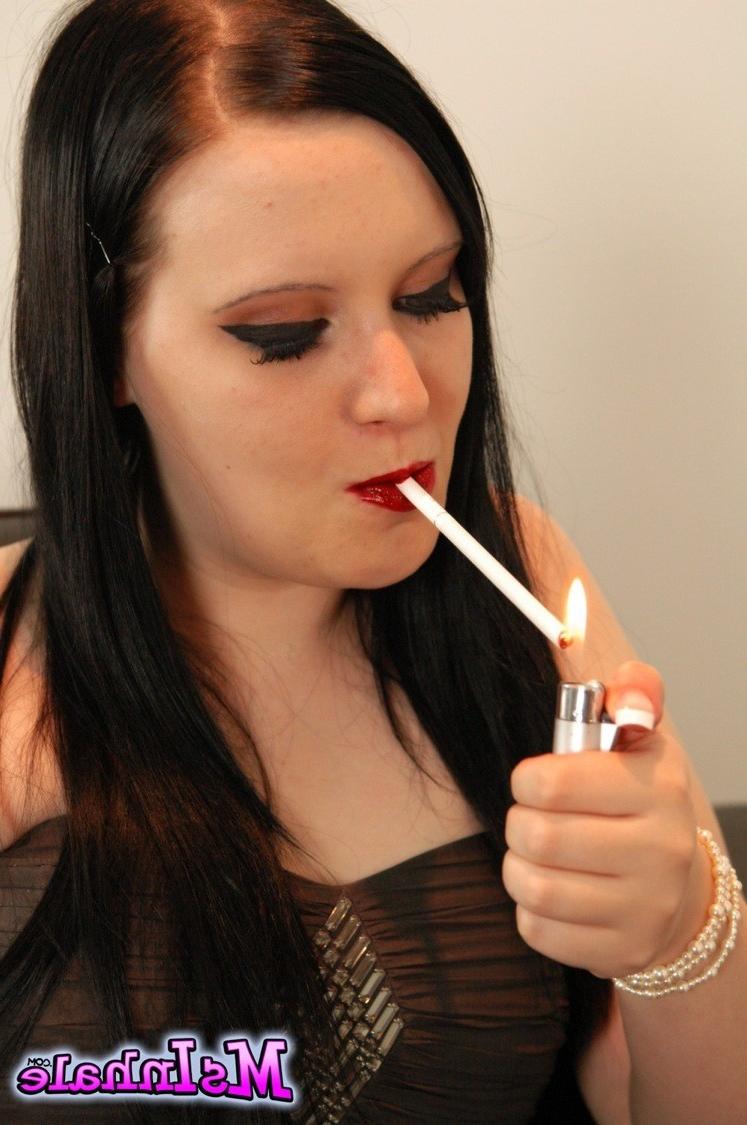 16P Naughty girl pulls her tits our of her dress as she smokes a lon