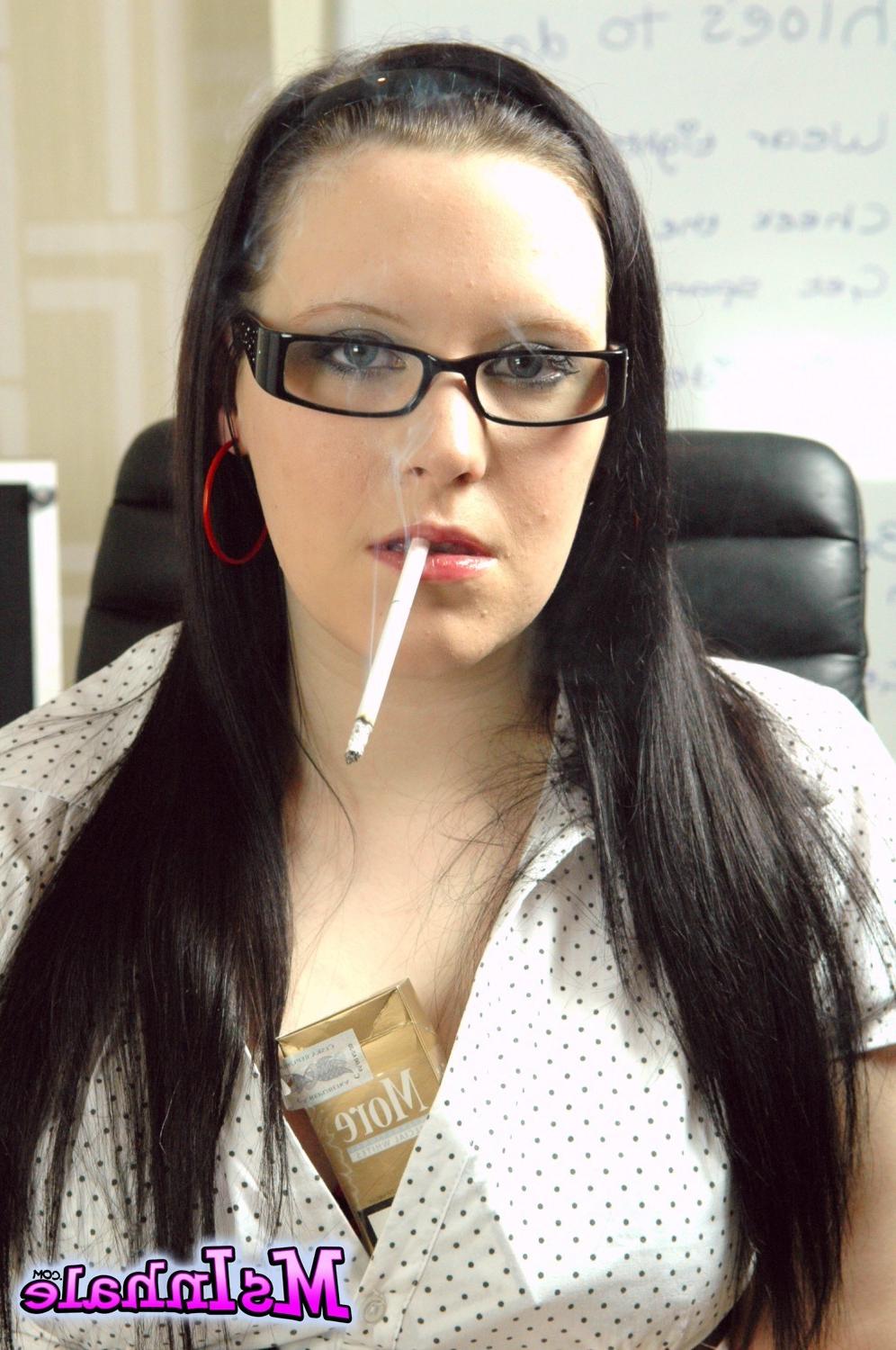 15P Teen secretary in glasses smoking a More 120 cigarette at work