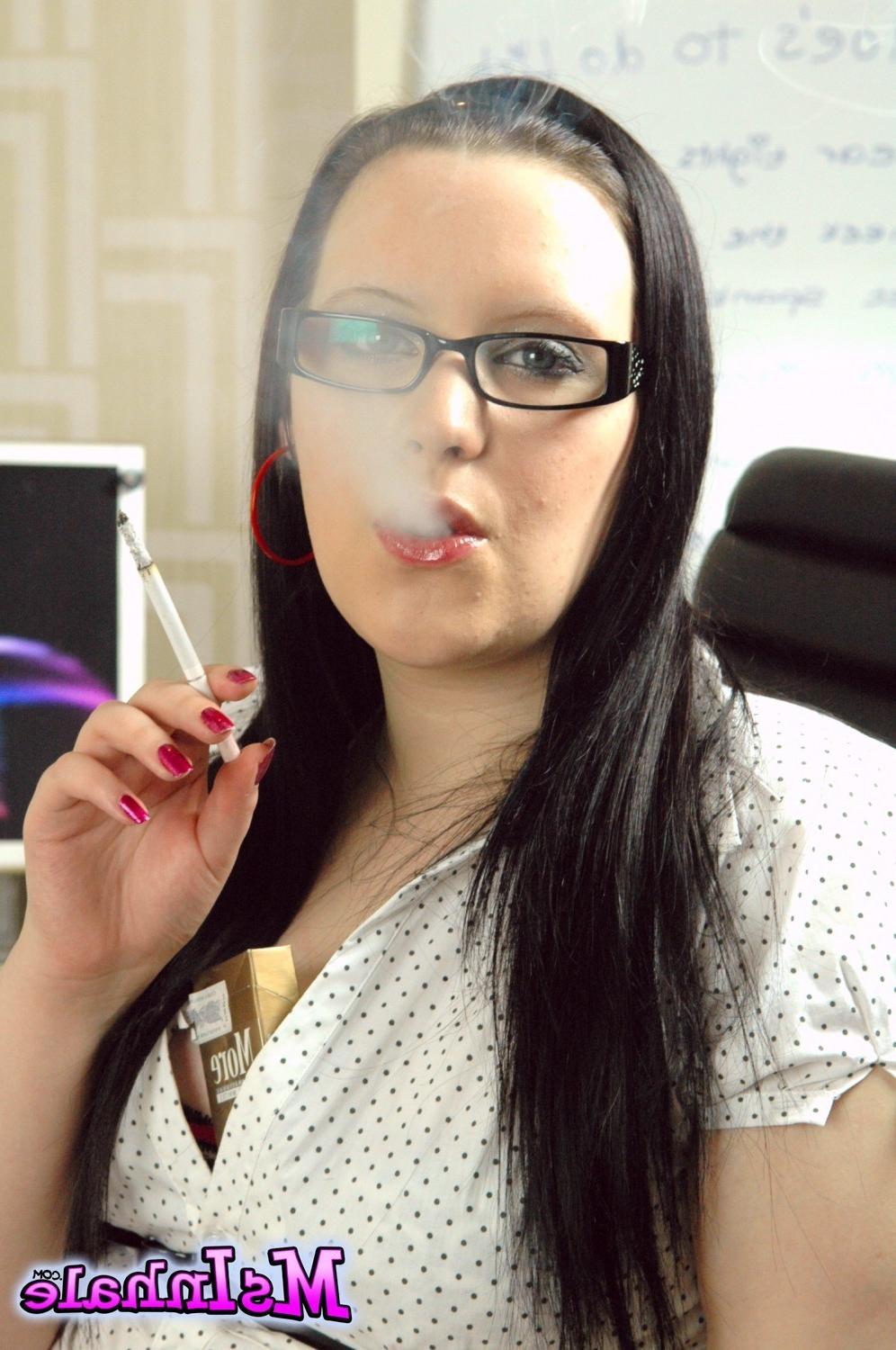15P Teen secretary in glasses smoking a More 120 cigarette at work