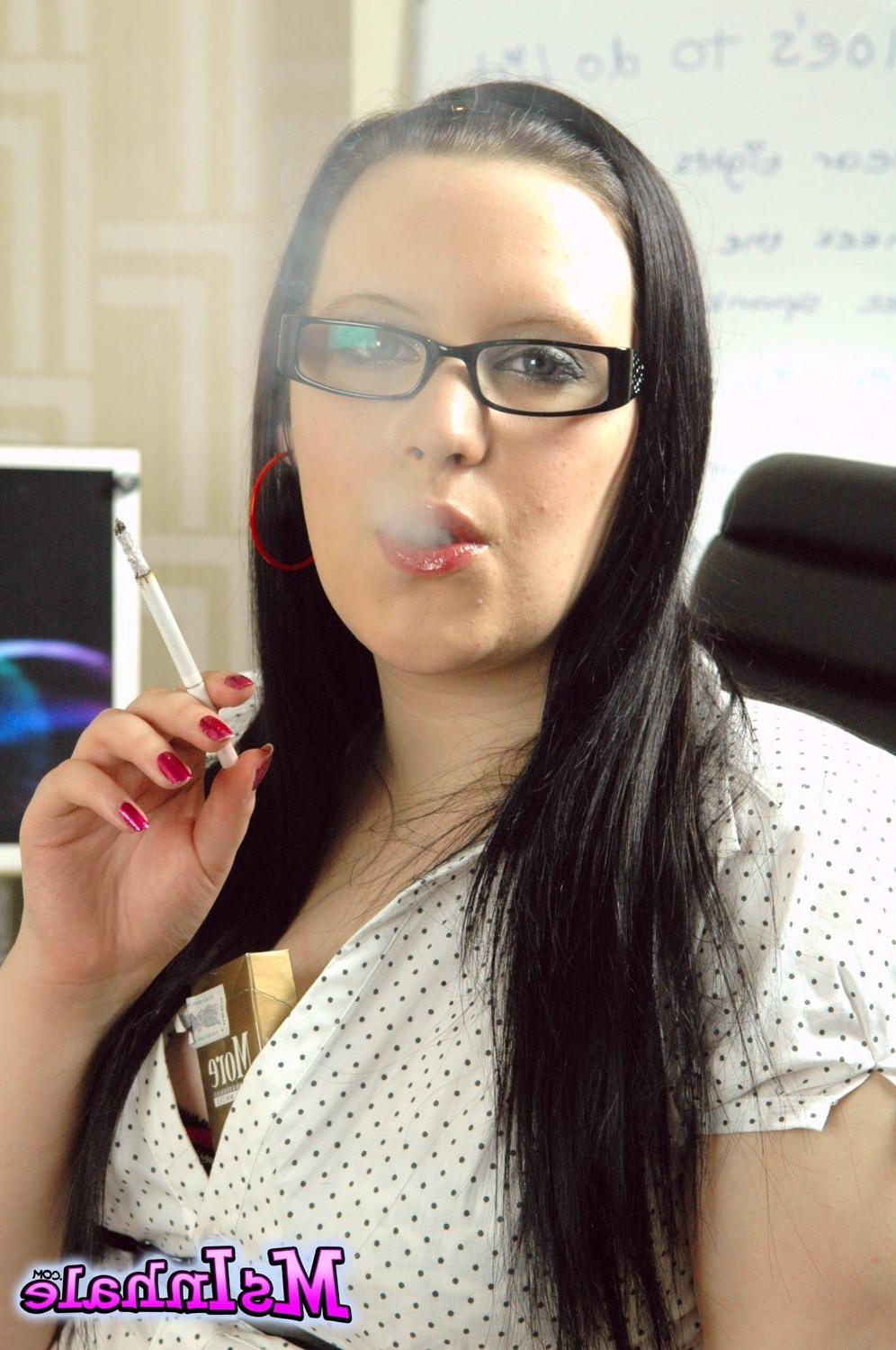 15P Teen secretary in glasses smoking a More 120 cigarette at work