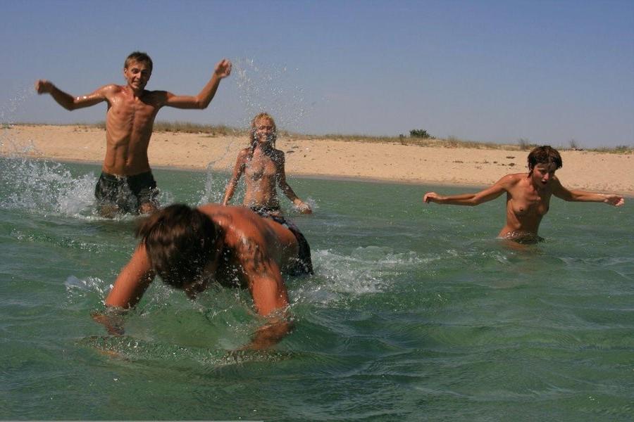 15P These two teen nudists play frisbee in the water