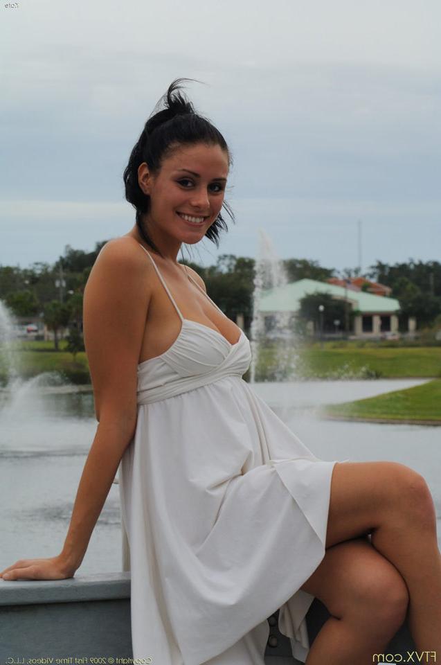 15P A shaved brunette babe lifting her dress in public