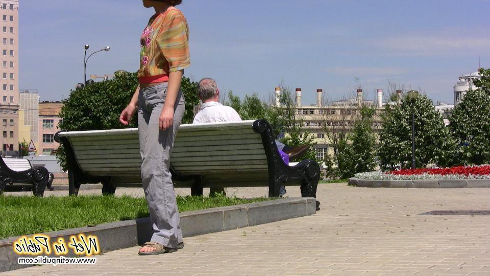 16P Desperate lady relieves herself on the move wetting her jeans in a park