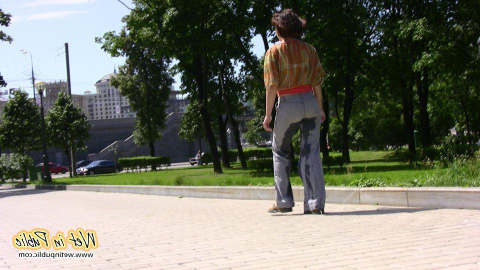 16P Desperate lady relieves herself on the move wetting her jeans in a park
