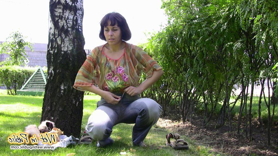 16P Desperate lady relieves herself on the move wetting her jeans in a park