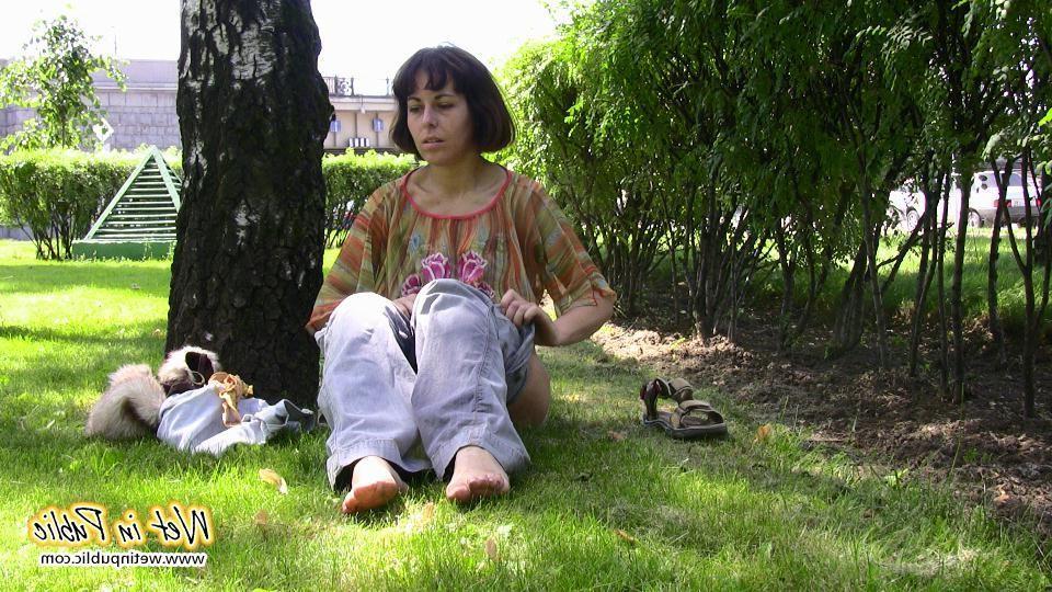 16P Desperate lady relieves herself on the move wetting her jeans in a park