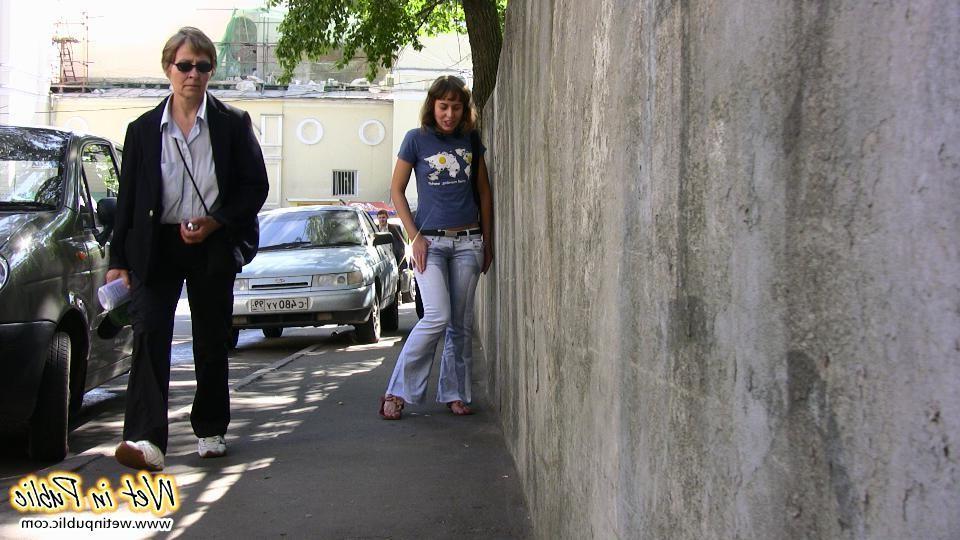 15P Huge ugly piss blotch on the tight jeans of a curvy outdoor bitchie