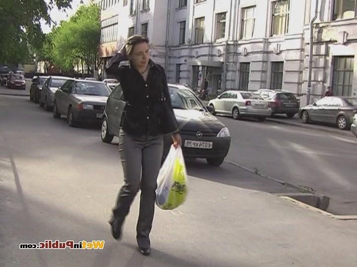 15P Perplexed brune walks in the street in pee-drenched tight gray pants