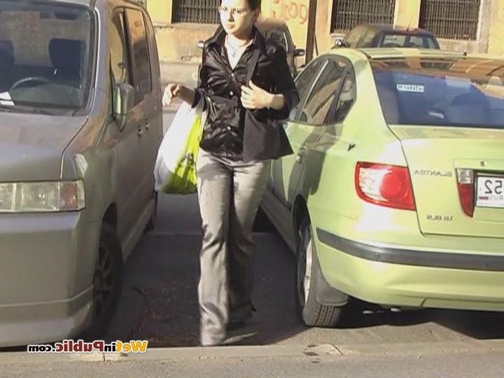 15P Perplexed brune walks in the street in pee-drenched tight gray pants