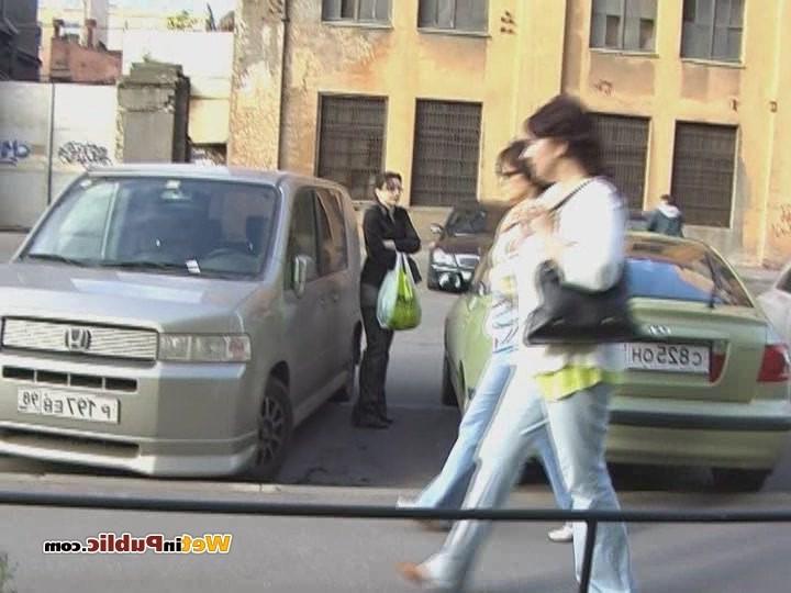 15P Perplexed brune walks in the street in pee-drenched tight gray pants
