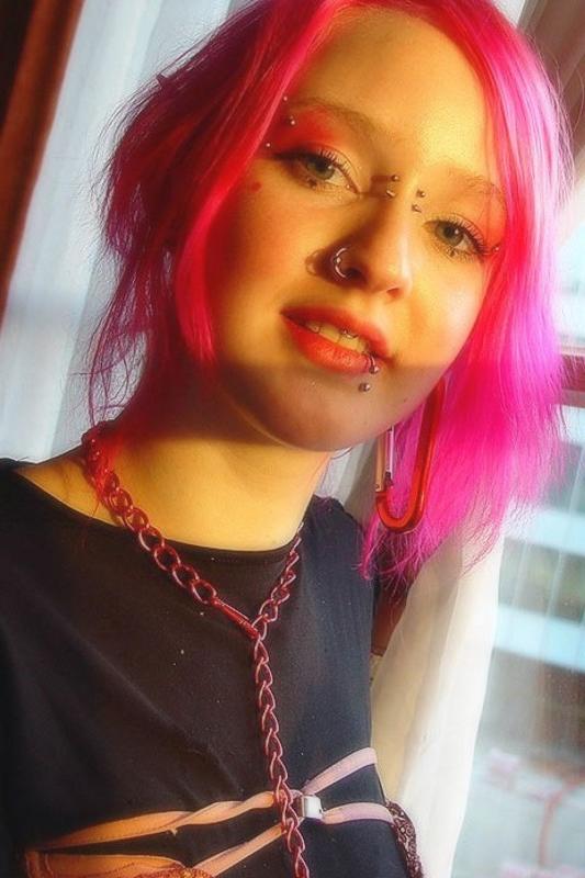 15P Pink haired gothic fetish chick showing off  her pierced boobs