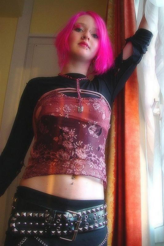 15P Pink haired gothic fetish chick showing off  her pierced boobs