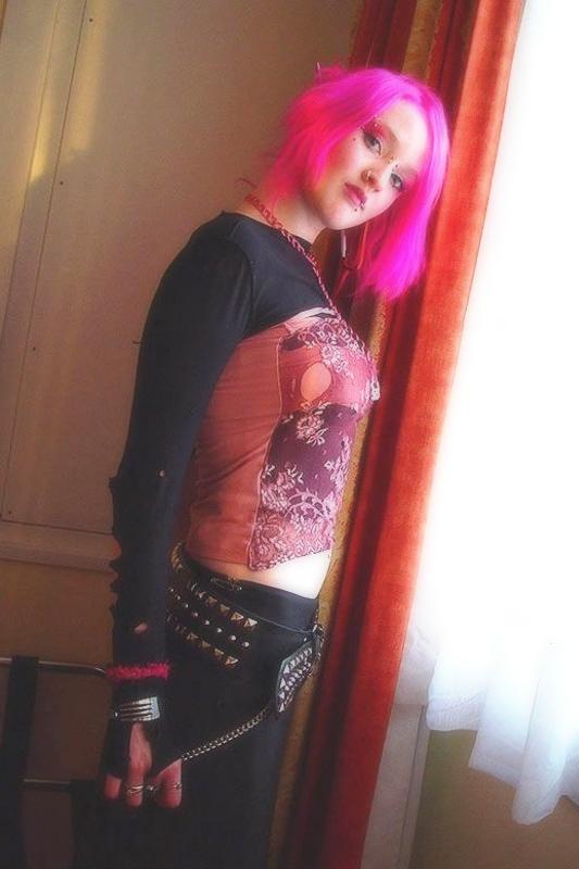15P Pink haired gothic fetish chick showing off  her pierced boobs