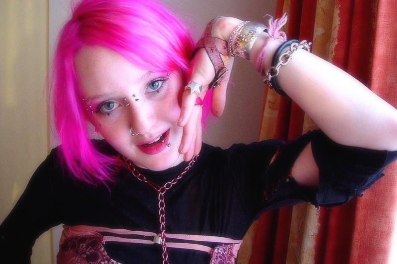 15P Pink haired gothic fetish chick showing off  her pierced boobs