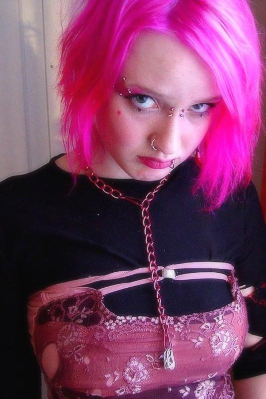15P Pink haired gothic fetish chick showing off  her pierced boobs
