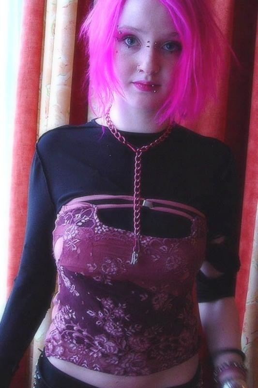 15P Pink haired gothic fetish chick showing off  her pierced boobs