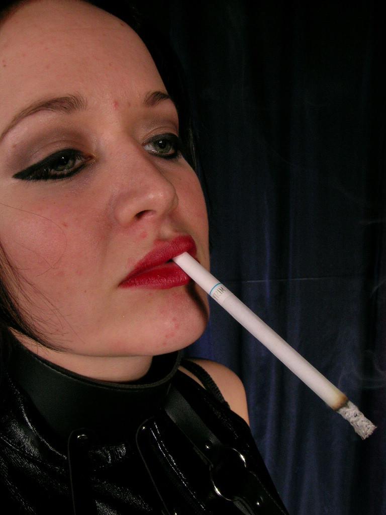 16P Sexy hot mistress wearing only leather smokes long cigarette