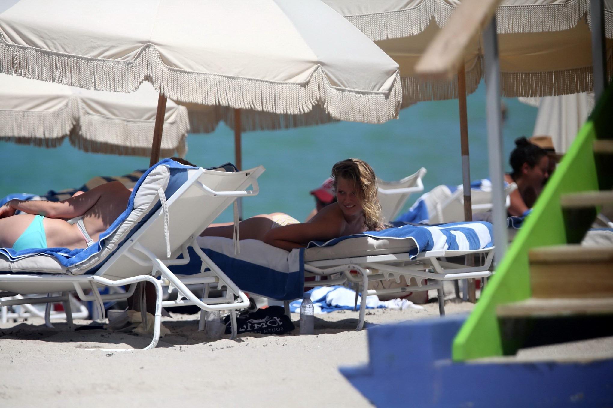 16P Toni Garrn topless tanning her back