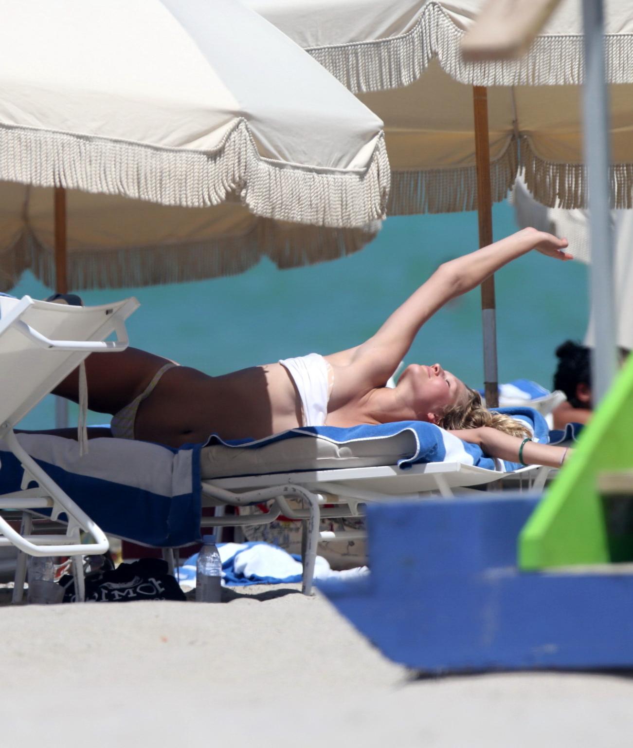 16P Toni Garrn topless tanning her back