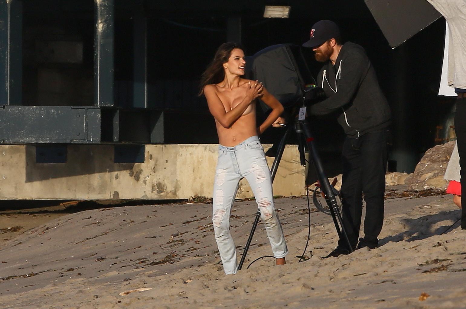 16P Alessandra Ambrosio topless trying to hide her big boobs while shooting at the b