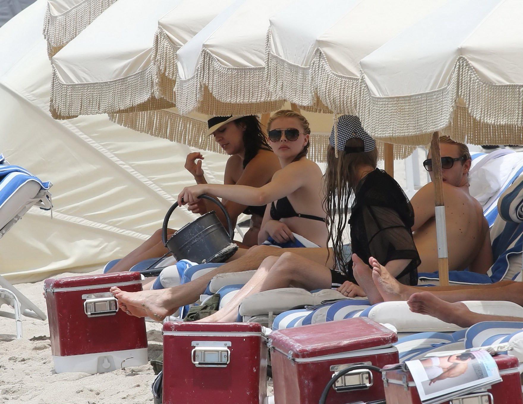 16P Chloe Moretz shows off her juicy ass in a skimpy black bikini at the beach in Mi