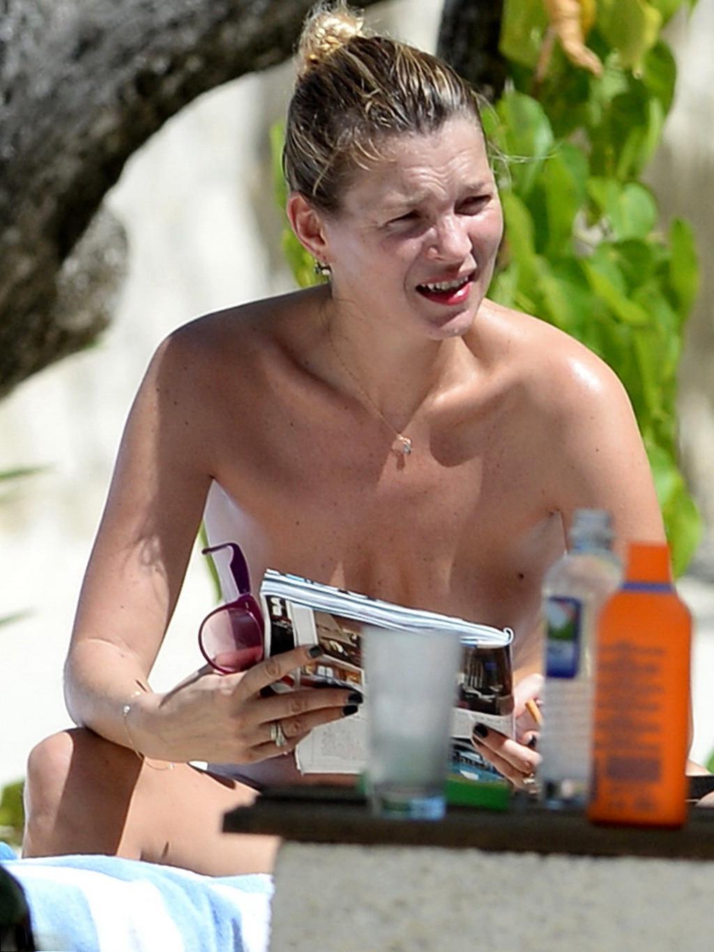 16P Kate Moss tanning topless on a beach in Jamaica