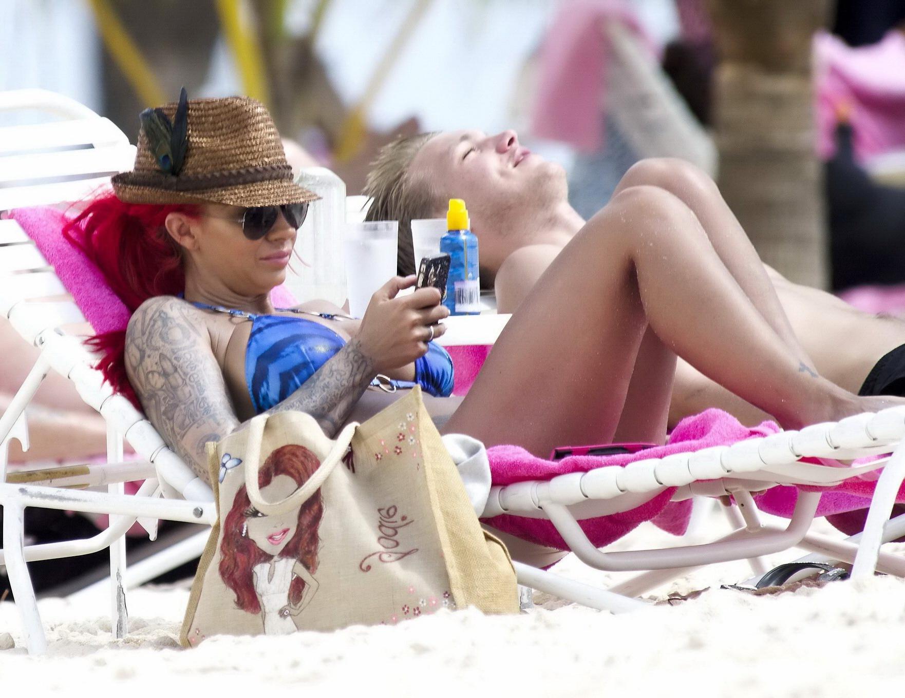 10P Busty Jodie Marsh tanning topless on a beach in Barbados