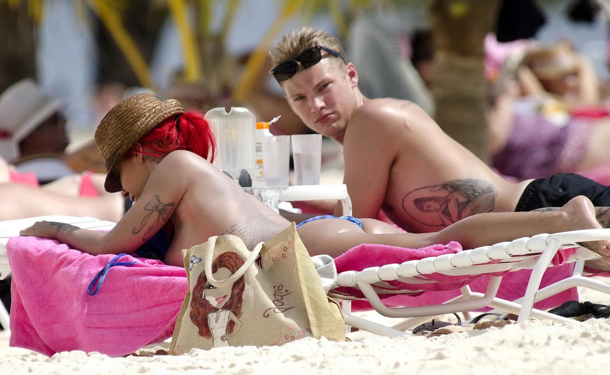 10P Busty Jodie Marsh tanning topless on a beach in Barbados