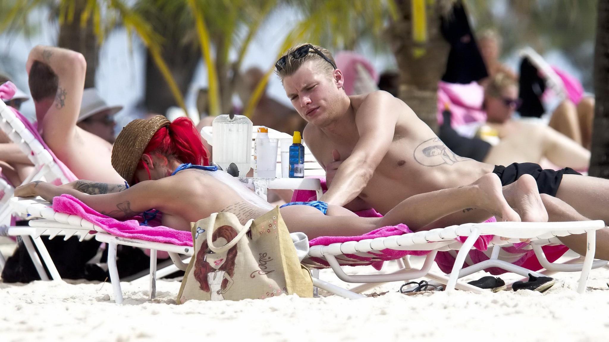 10P Busty Jodie Marsh tanning topless on a beach in Barbados