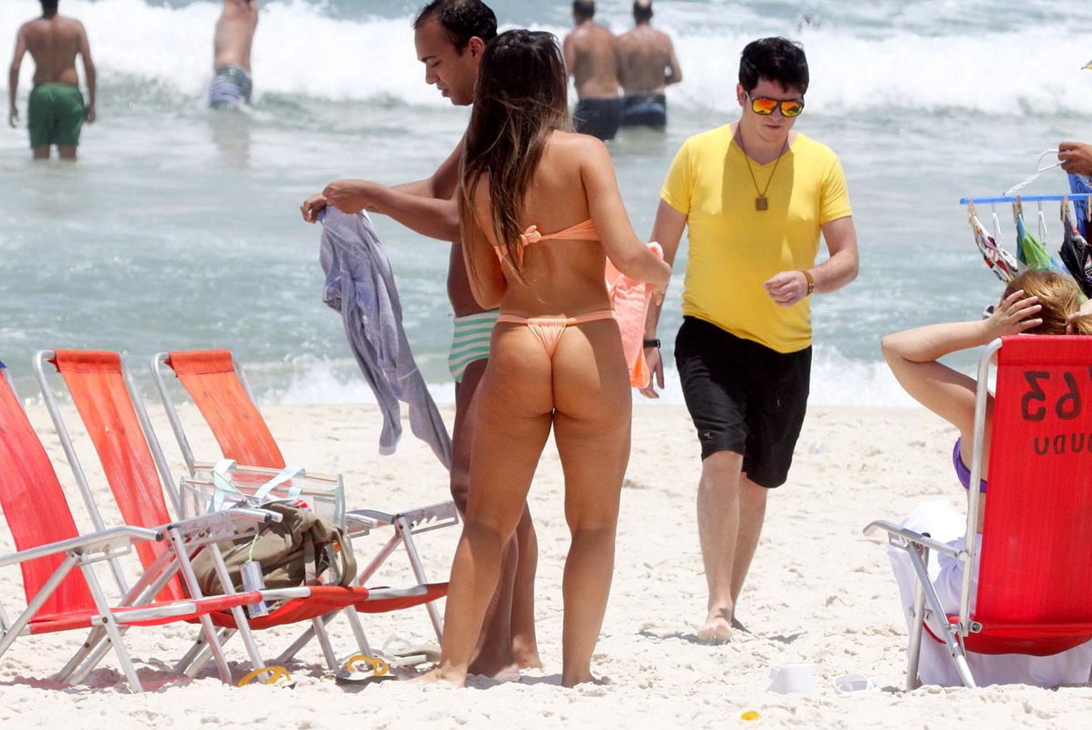10P Nicole Bahls showing off her boobs  ass while tanning topless on a beach in Rio
